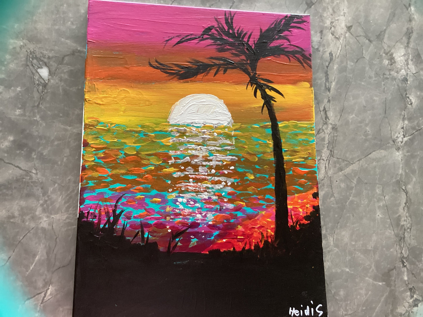 I painting a sunset on the beach and when you look at it very far away it looks like the sun reflecting on the water .￼￼￼￼